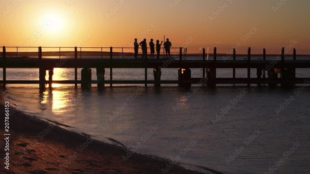 A full shot of silhouette people on the pier A full shot of silhouette people on the pier