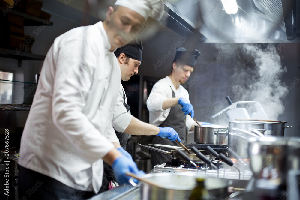 Group of chefs working in the kitchen Group of chefs working in the kitchen