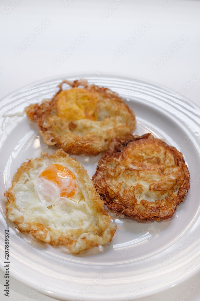 Three fried eggs on white plate and selective focus Three fried eggs on white plate and selective focus