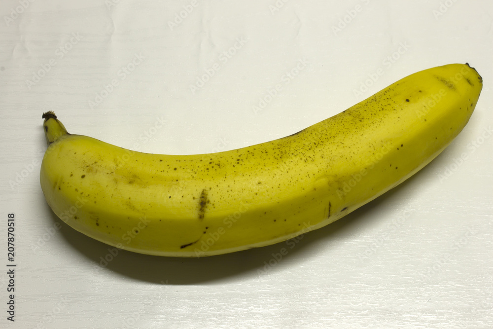 Banana isolated on a White textured background with a dark shadow