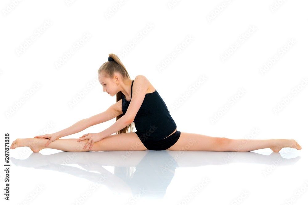 Girl gymnast perform the twine exercise. Girl gymnast perform the twine exercise.