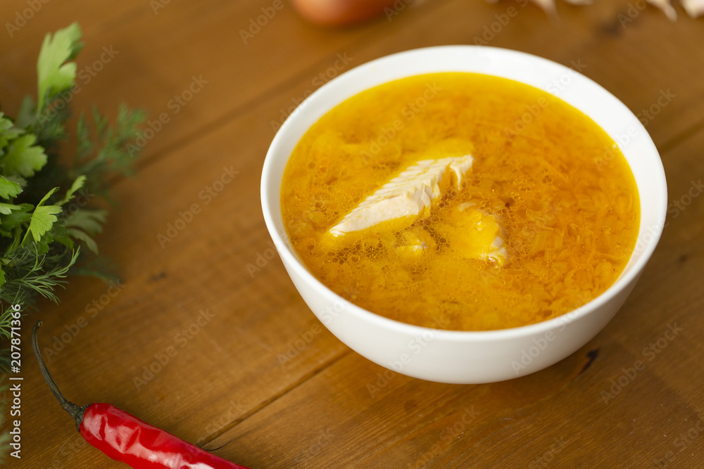 Fresh fish soup with ingredients and spices for cooking. Wooden background Fresh fish soup with ingredients and spices for cooking. Wooden background