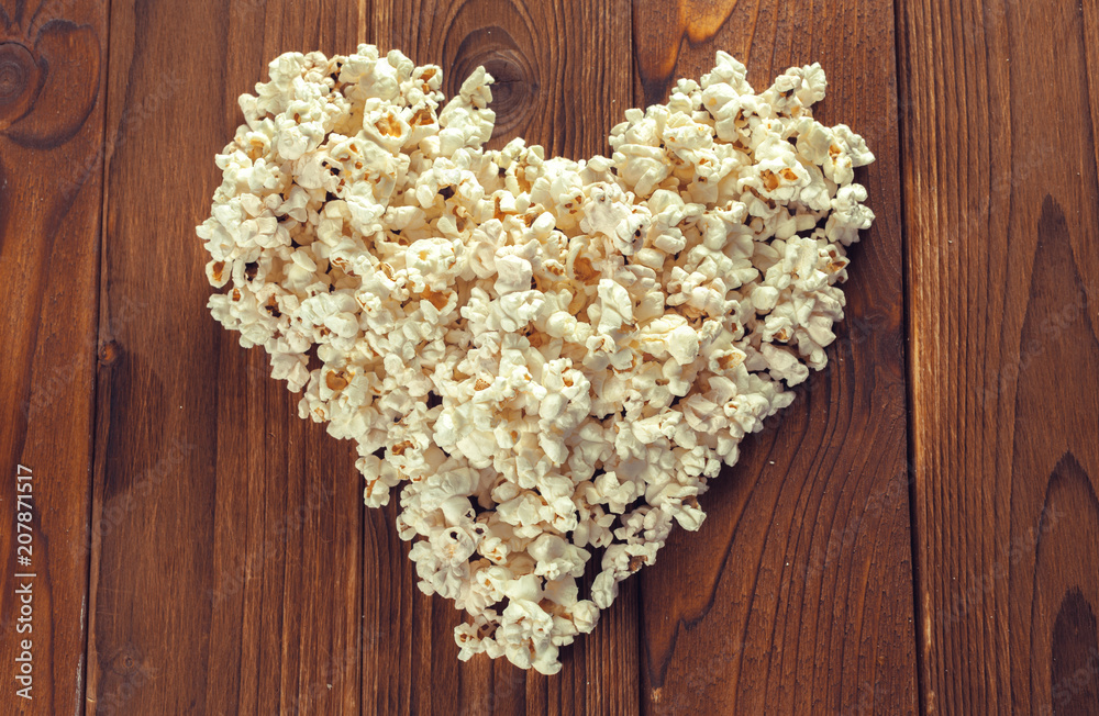 Salt popcorn on the wooden table Salt popcorn on the wooden table