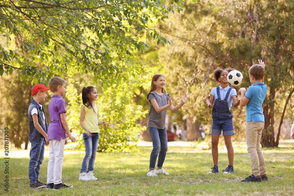 Cute little children playing with ball outdoors on sunny day Cute little children playing with ball outdoors on sunny day