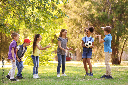 Cute little children playing with ball outdoors on sunny day