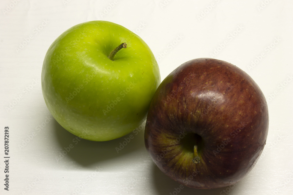 Green and Red Apples isolated on a White textured background with a dark shadow Green and Red Apples isolated on a White textured background with a dark shadow