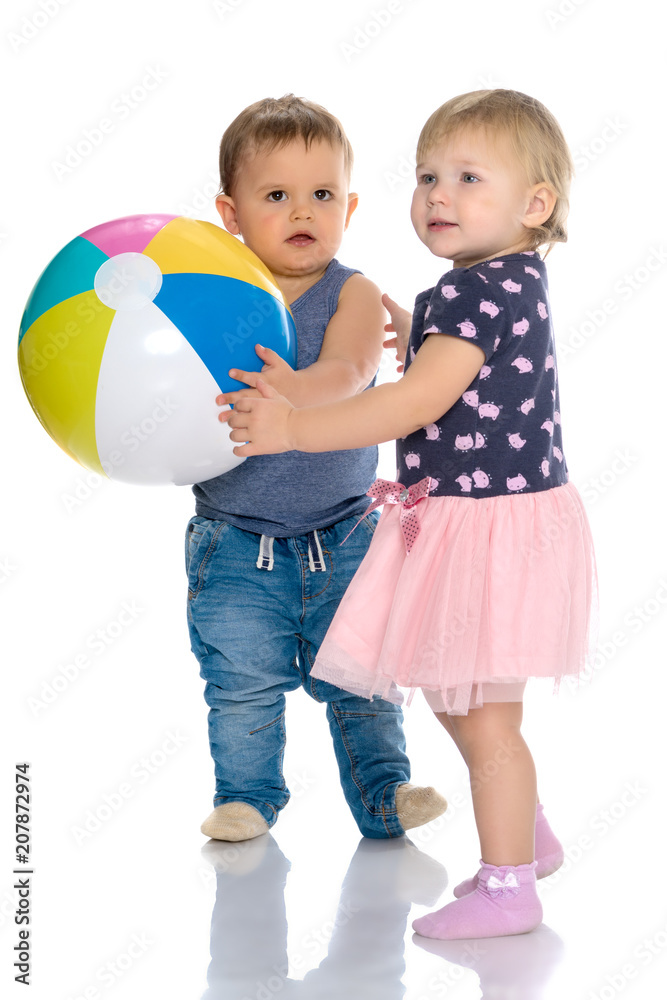 Toddler boy and girl playing with ball. Toddler boy and girl playing with ball.