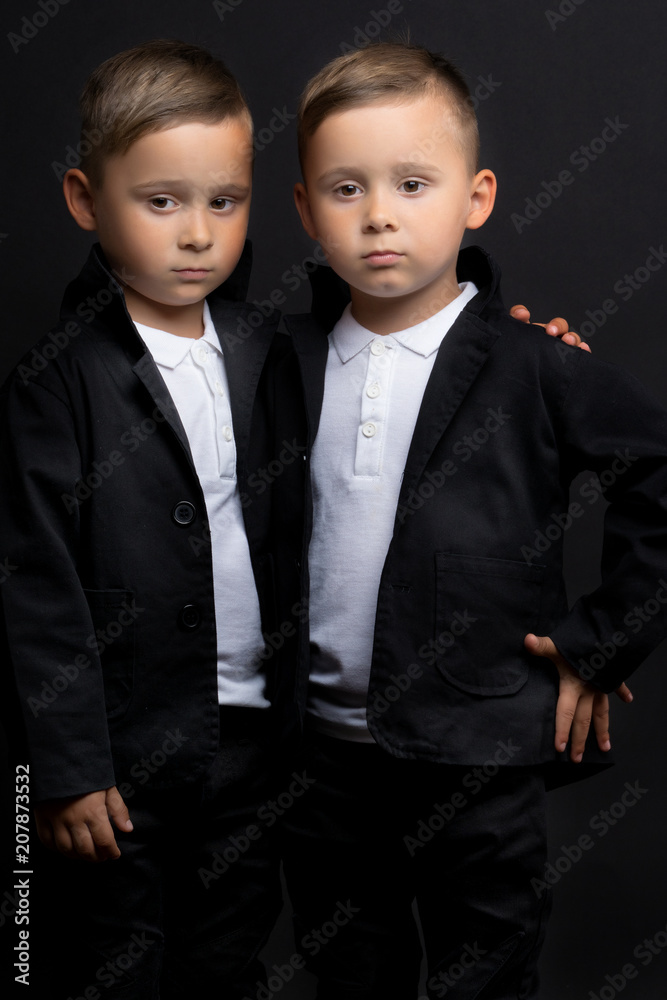 Two beautiful boys in black suits