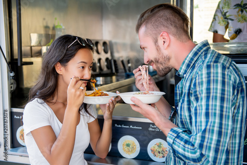 Couple eating pasta at food truck