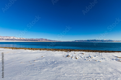   The frozen Sailimu lake with snow mountain background at Yili  Xinjiang of China