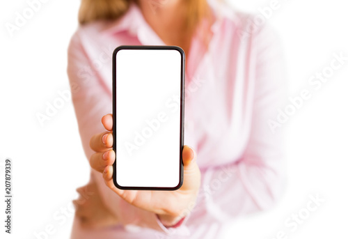Woman showing phone with empty white screen. Mobile app mockup. photo