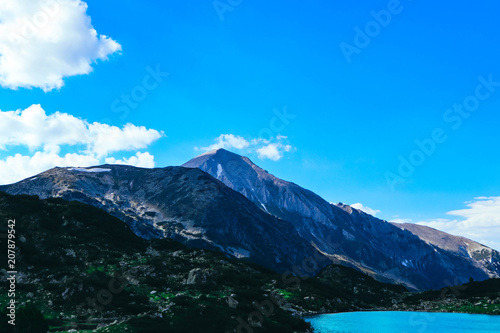 Fototapeta Naklejka Na Ścianę i Meble -  Beautiful alpine lake, river in the high mountains peak, blue sky background. Amazing Mountain hiking paradise landscape, summertime.