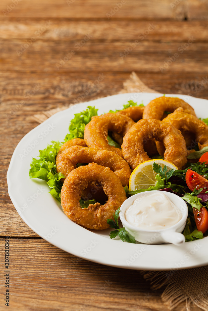 Roasted squid rings with salad. Roasted squid rings with salad.