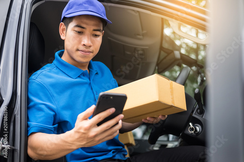 messenger man hold box and talk on smart phone and payment terminal in hands, Package delivery concept.