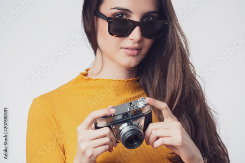 Woman holding photography vintage camera © guerrieroale
