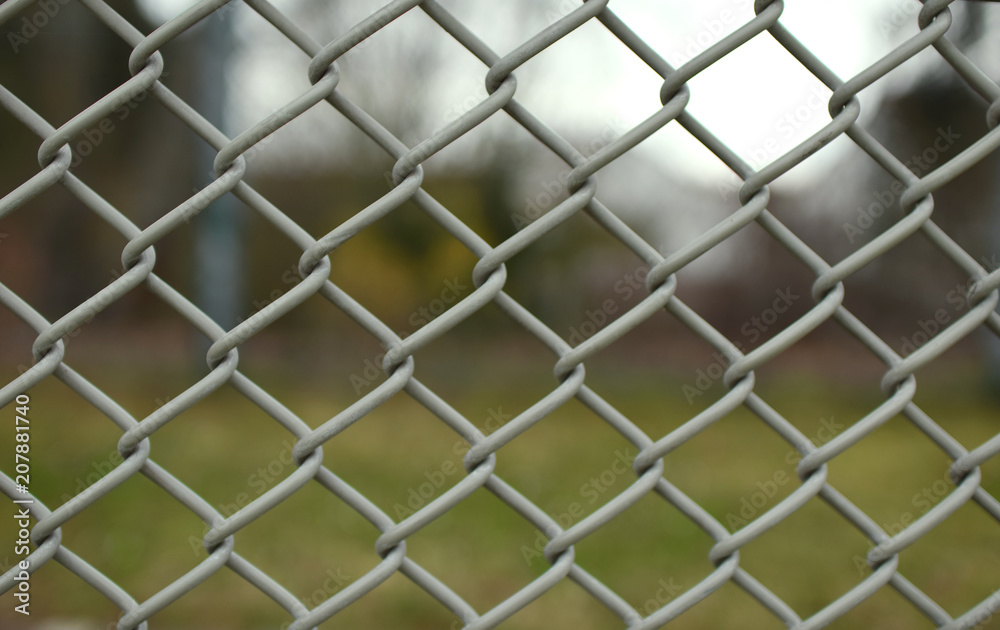 Closeup of grey mesh fence Closeup of grey mesh fence
