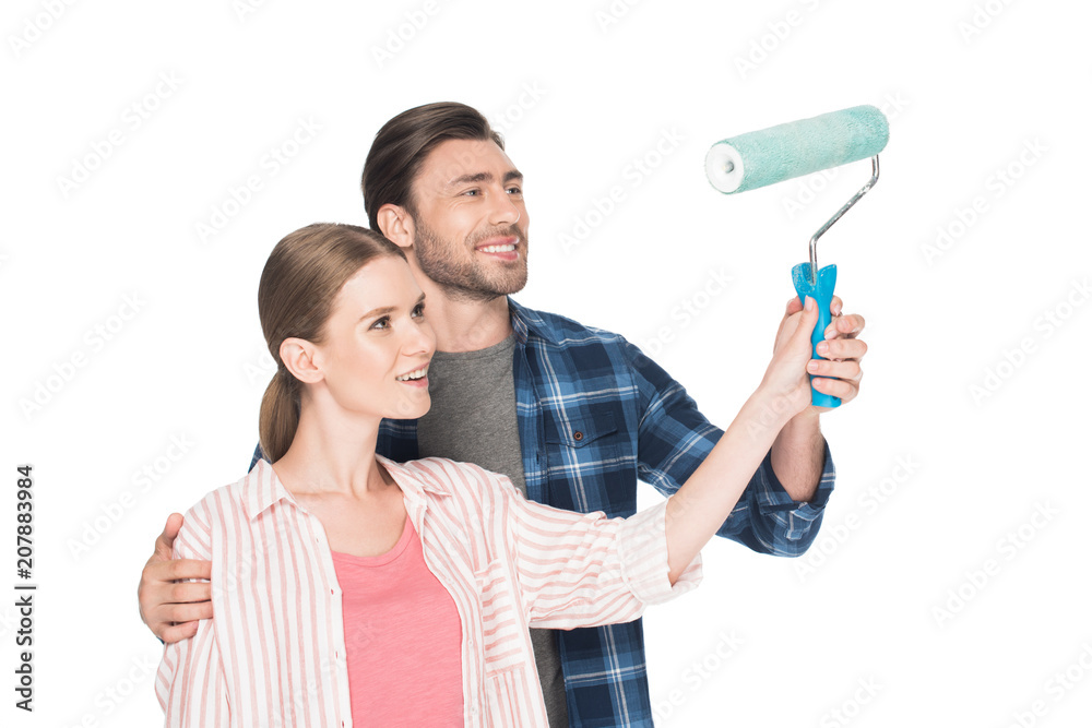 smiling man teaching girlfriend painting by paint roller isolated on white background smiling man teaching girlfriend painting by paint roller isolated on white background