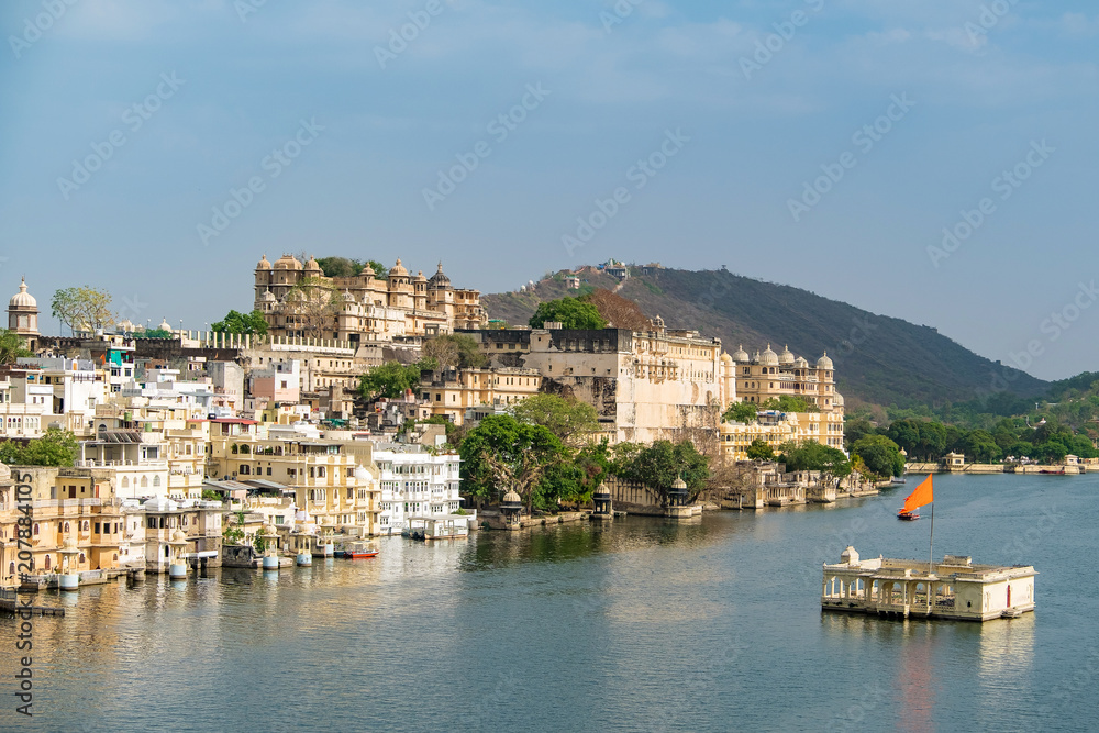 Udaipur city at lake Pichola in the morning, Rajasthan, India. View of City palace reflected on the lake.