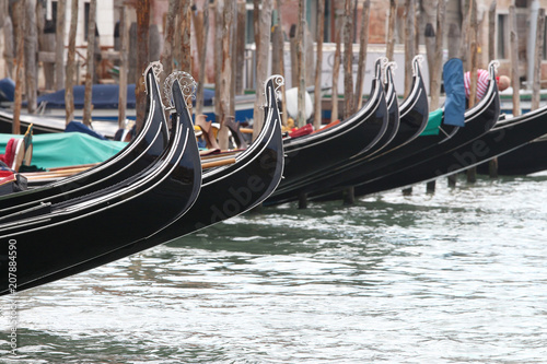 gondolas lined up on the banks of the grand canal in venice