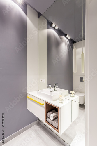 Mirror in grey bathroom interior