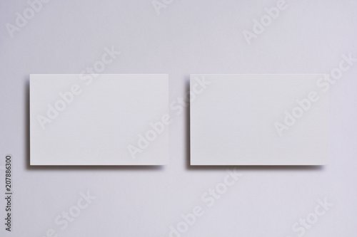 Photo of blank white business cards on white. Mock-up for branding identity. For graphic designers presentations and portfolios © trimailova