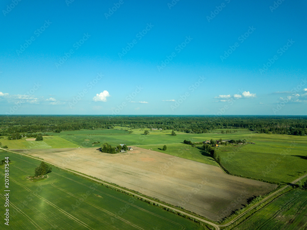 drone image. aerial view of countryside road network, cultivated fields and forest textures