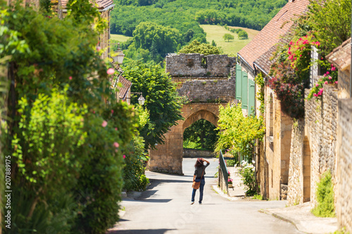 Old street of Domme village in Dordogne department, France