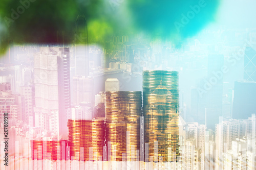 Double exposure of coin stack and little tree on city background with financial graph chart, business planning vision and finance analysis concept.