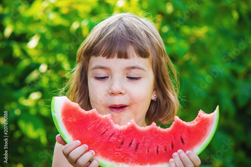 A child eats watermelon. Selective focus.