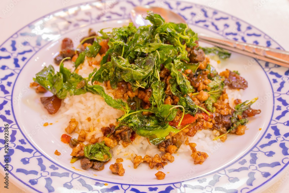 Stir fried basil leaf pork with rice and put the preserved egg.. Stir fried basil leaf pork with rice and put the preserved egg..