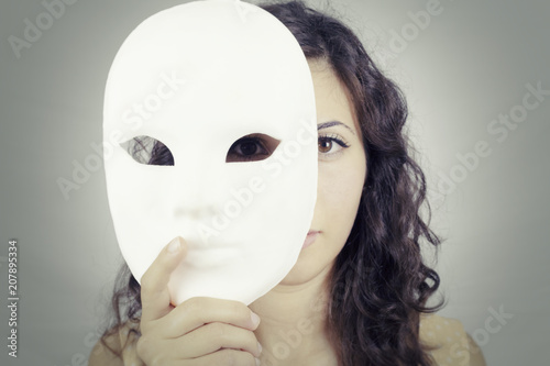 A cute girl hiding under a bright white mysterious mask. Proud  self-confident expression. Secrets, mystery, personality. Stock 写真 | Adobe  Stock