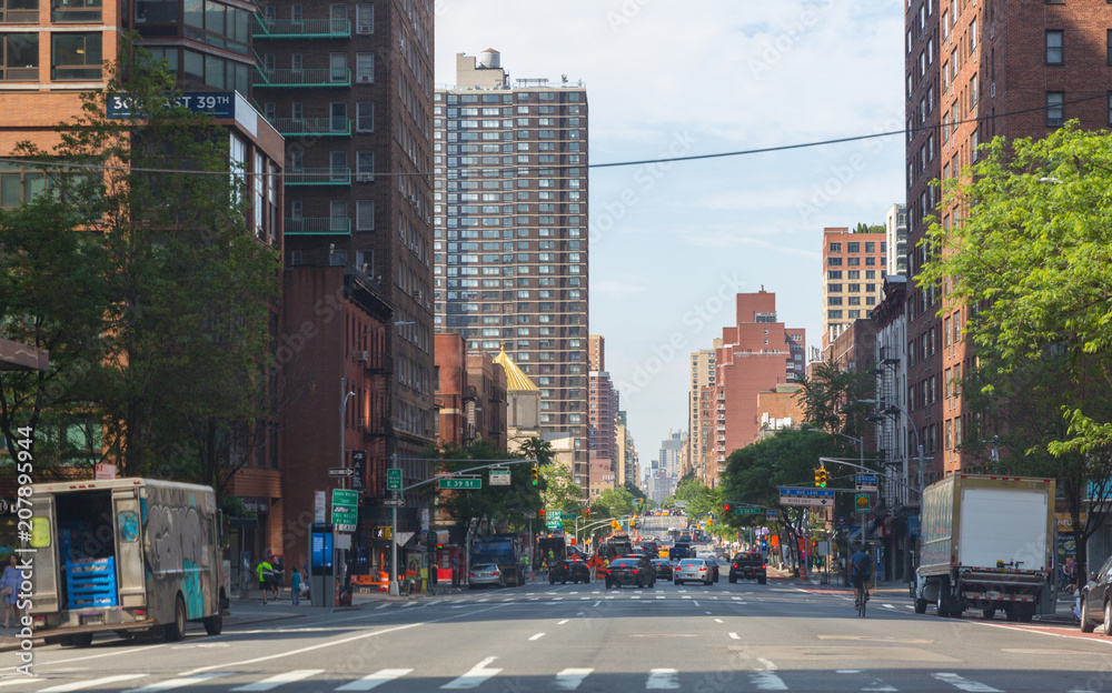 New York - June 2, 2018: A view down a busy avenue street, People walk on busy streets