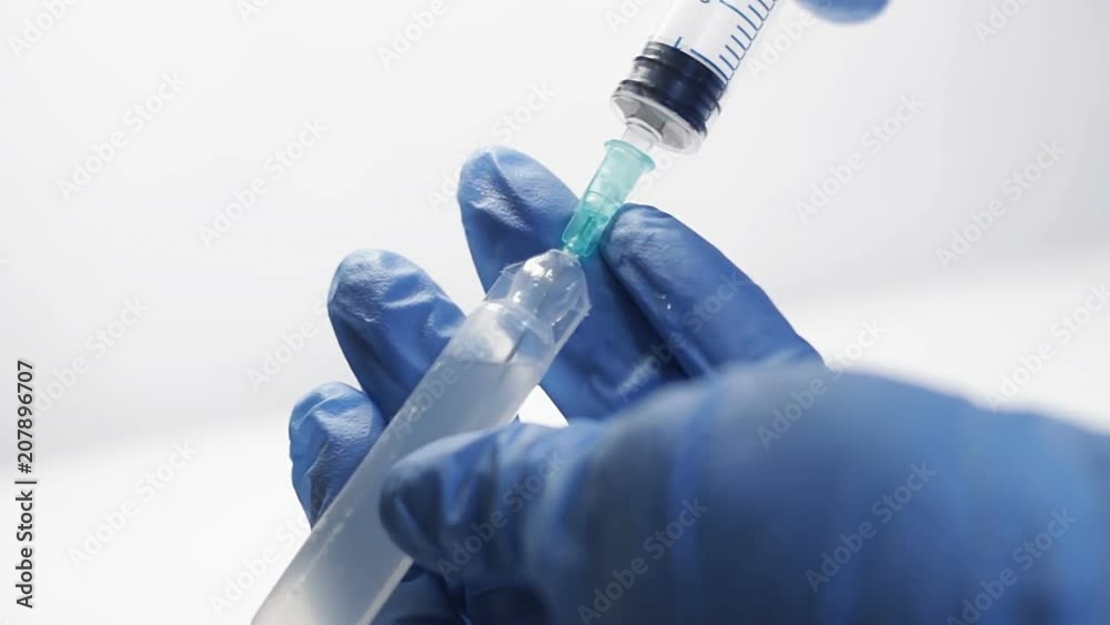 Intern sucking in syringe antidiarrhoeic medicine from plastic disposal ampoule Intern sucking in syringe antidiarrhoeic medicine from plastic disposal ampoule