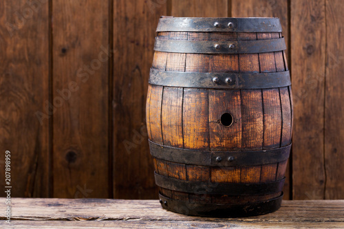 wooden barrel on rustic wooden background © Nitr