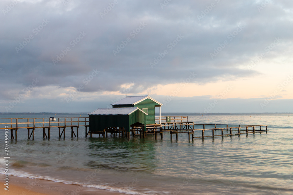 An empty coastline with green boathouse. An empty coastline with green boathouse.
