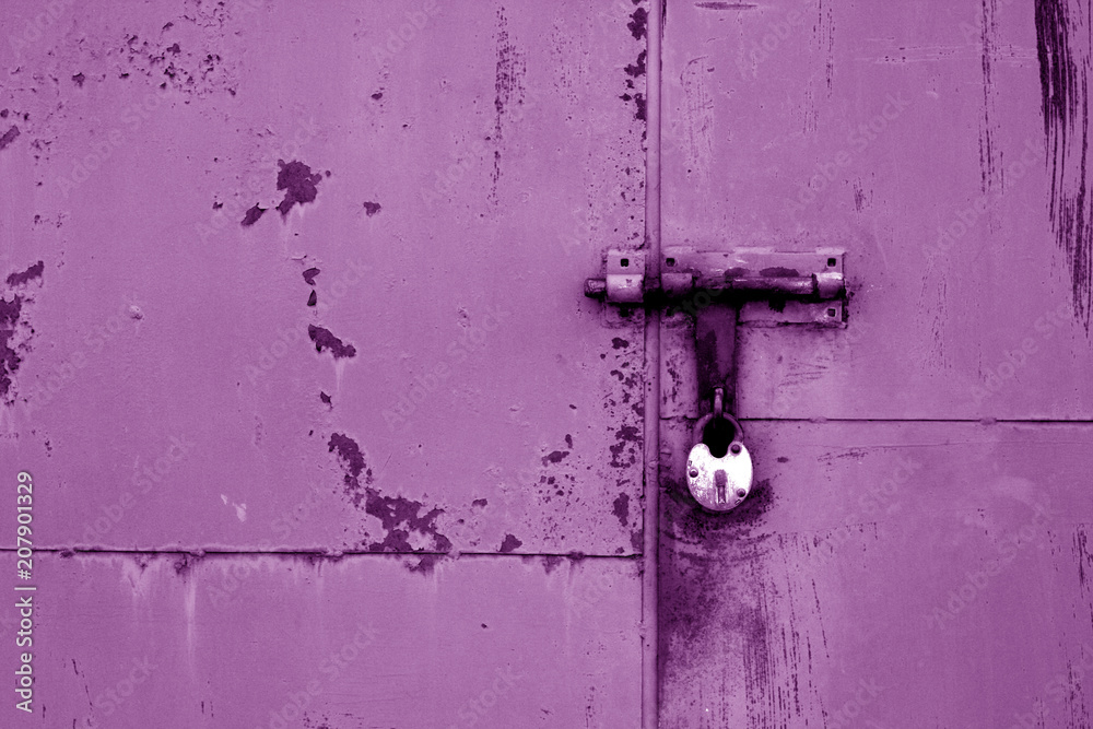 Old padlock on metal gate in purple color. Old padlock on metal gate in purple color.