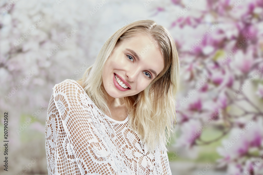 romantic blond girl smiling in a flower garden romantic blond girl smiling in a flower garden