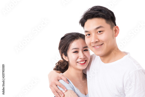 Happy young couple. Portrait of cheerful couple smiling looking at camera. 
