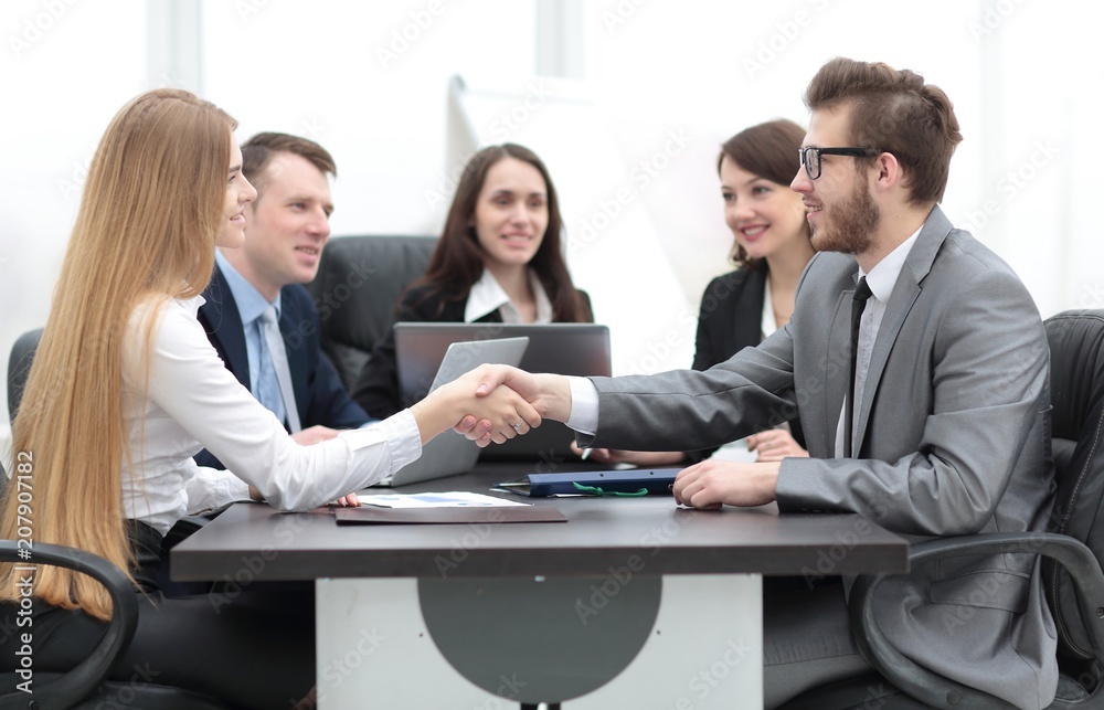 handshake between a businesswoman and a businessman