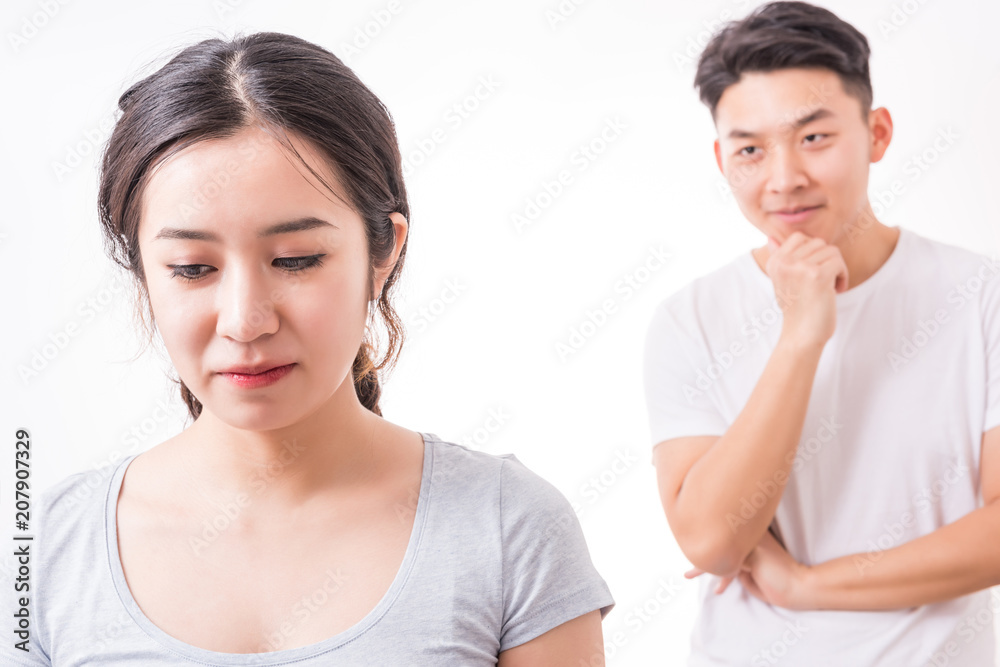 Couple in trouble. Young man looking at her girlfriend with a sly smile. Couple in trouble. Young man looking at her girlfriend with a sly smile.