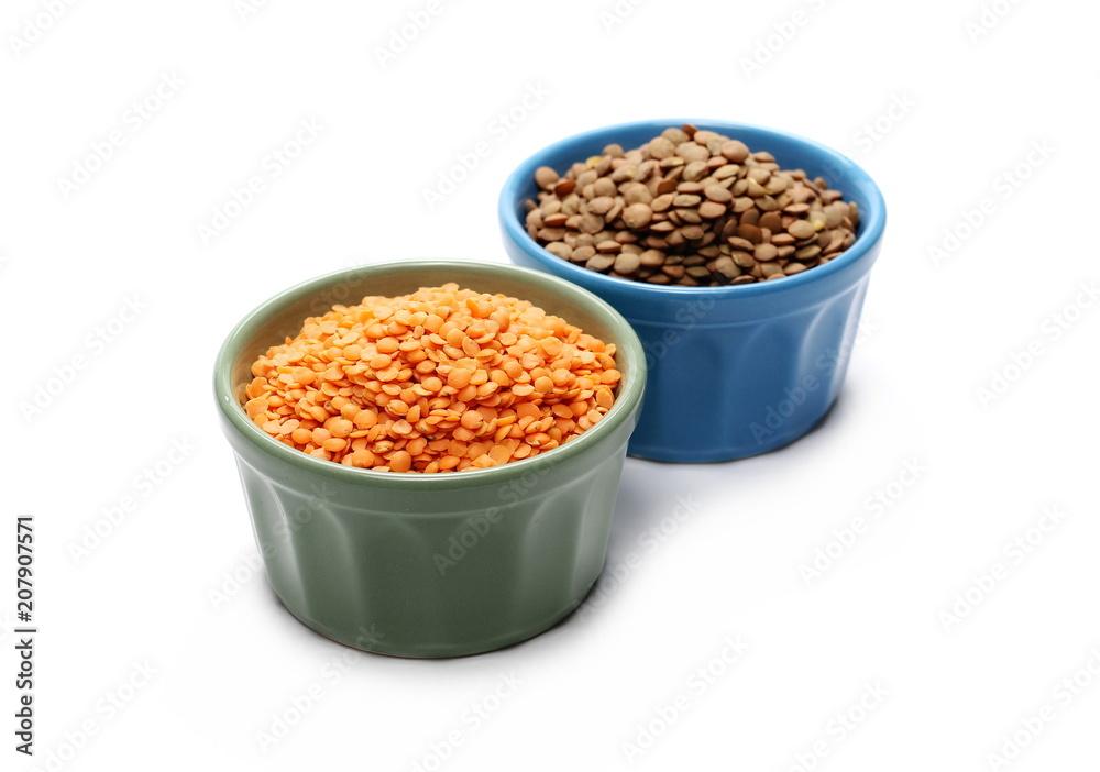 Red and green lentils in porcelain bowls, isolated on white background Red and green lentils in porcelain bowls, isolated on white background