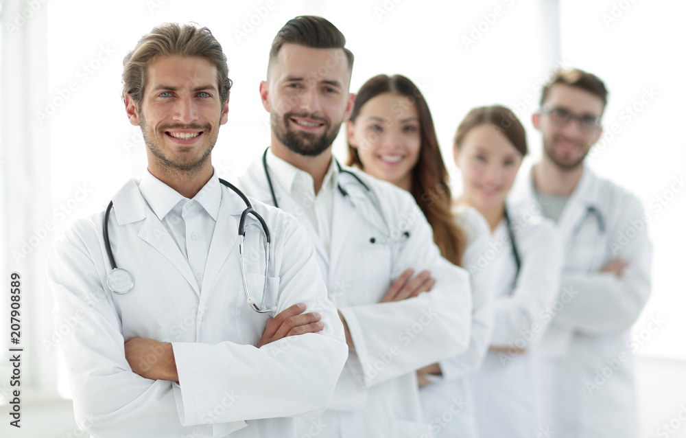 Portrait of medical team standing with arms crossed in hospital