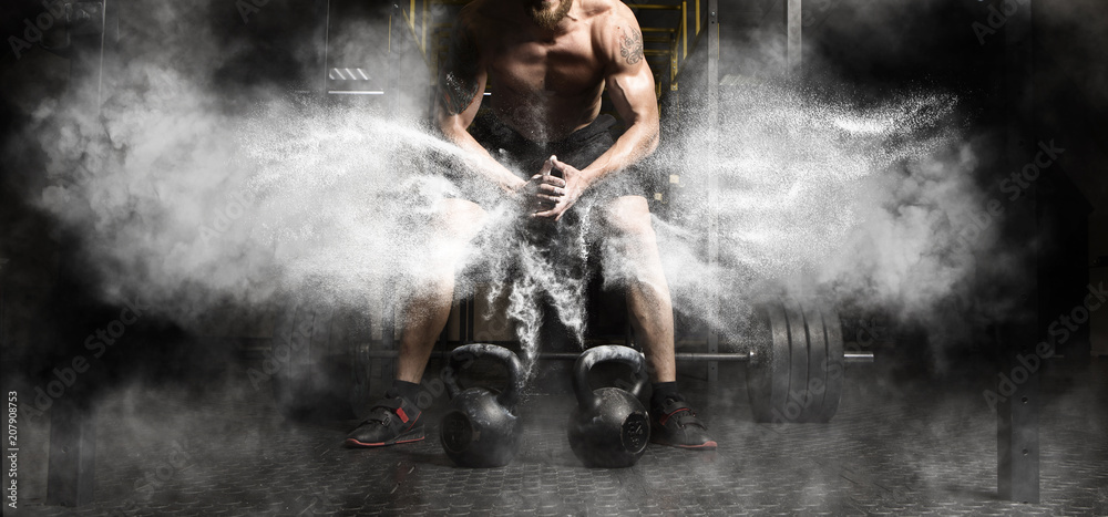 Fototapeta premium Mięśniowy mężczyzna trening z kettlebell przy gym