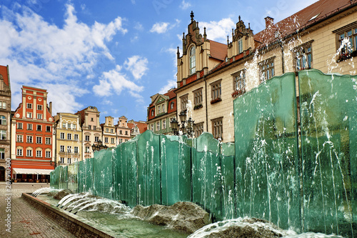 Central market square in Wroclaw Poland with old colorful houses and famouse fountain on a bright summer day. Travel vacation concept