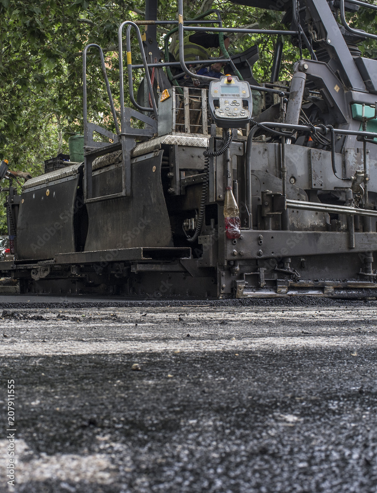 Paving applicator machine or paver at work Paving applicator machine or paver at work