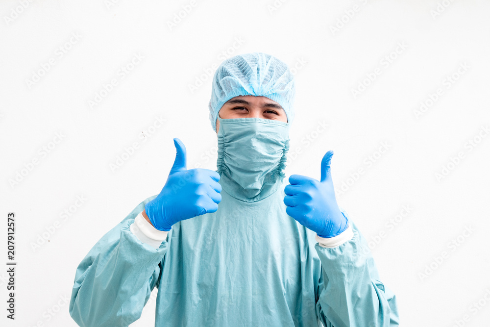 Portrait of a young surgeon making thumb up sign over white background. Portrait of a young surgeon making thumb up sign over white background.