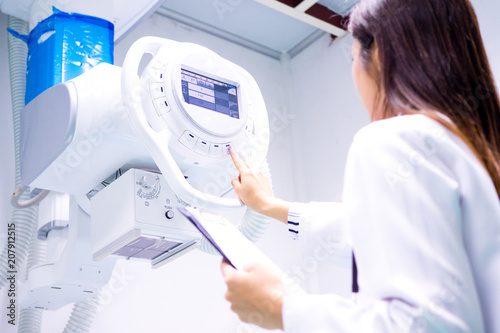 Smart doctor with CT scan machine in lab. photo