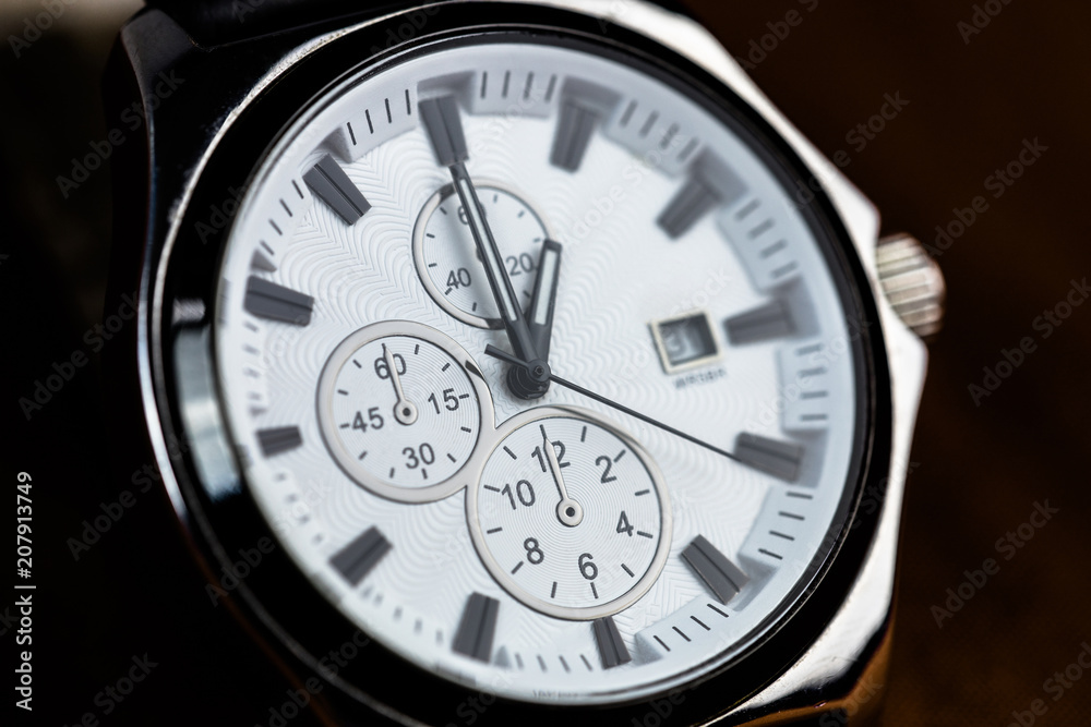 watch on a black background indicating the first hour watch on a black background indicating the first hour