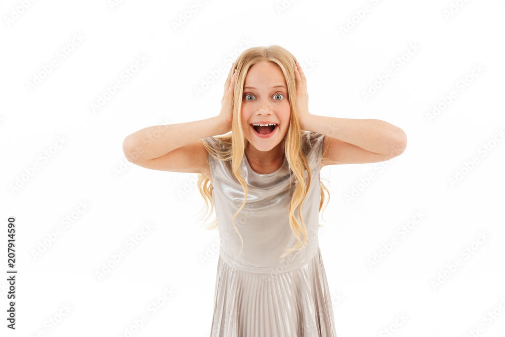Surprised happy young blonde girl in dress rejoices