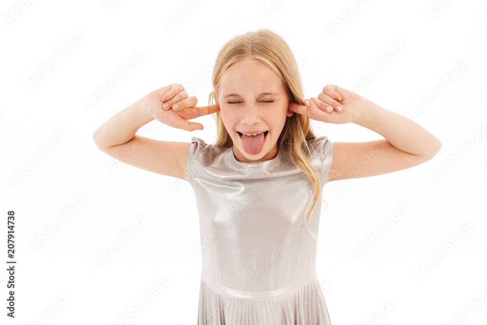Angry young blonde girl in dress screaming and covering ears Angry young blonde girl in dress screaming and covering ears